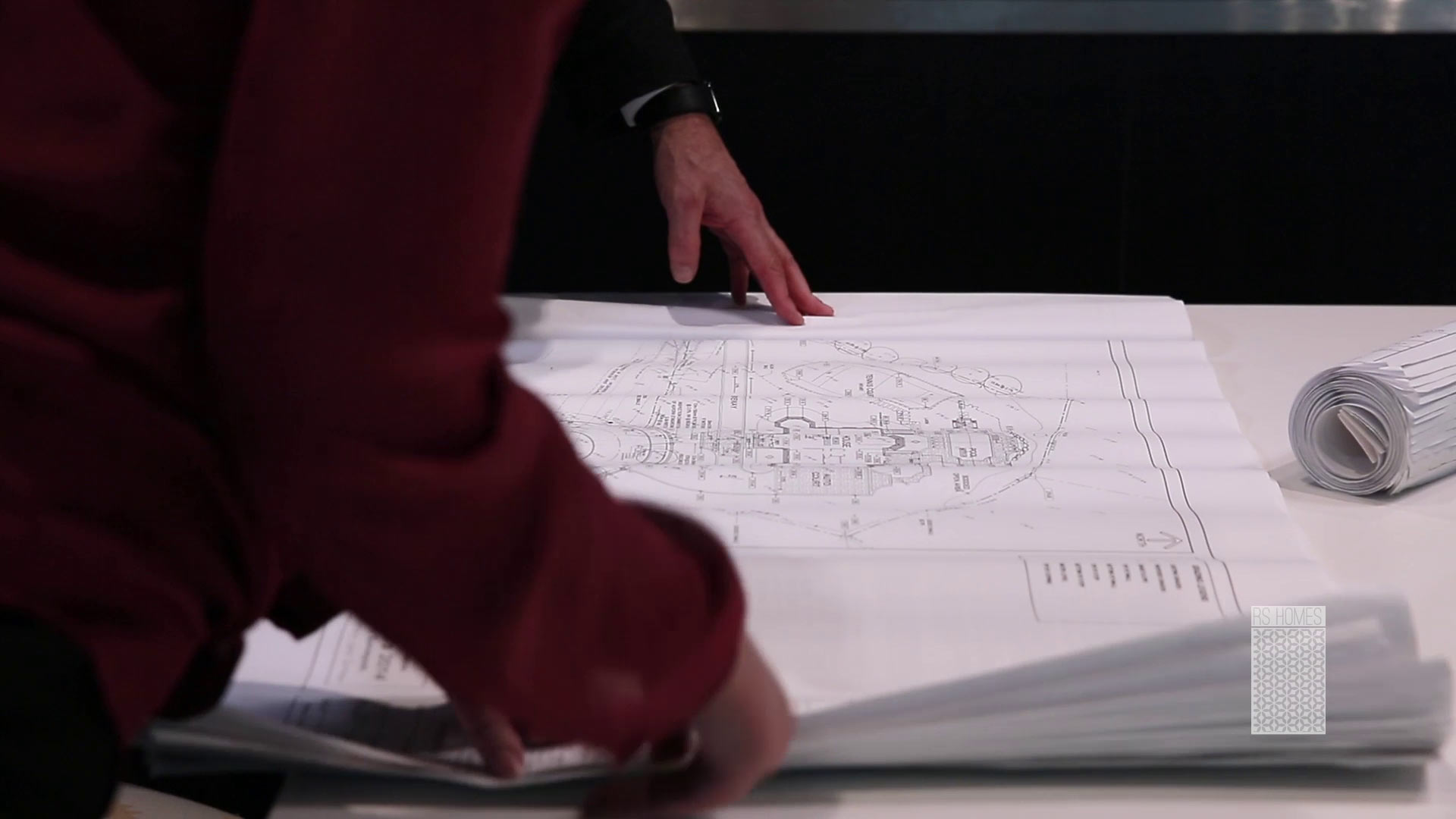 Men looking at a home building plan
